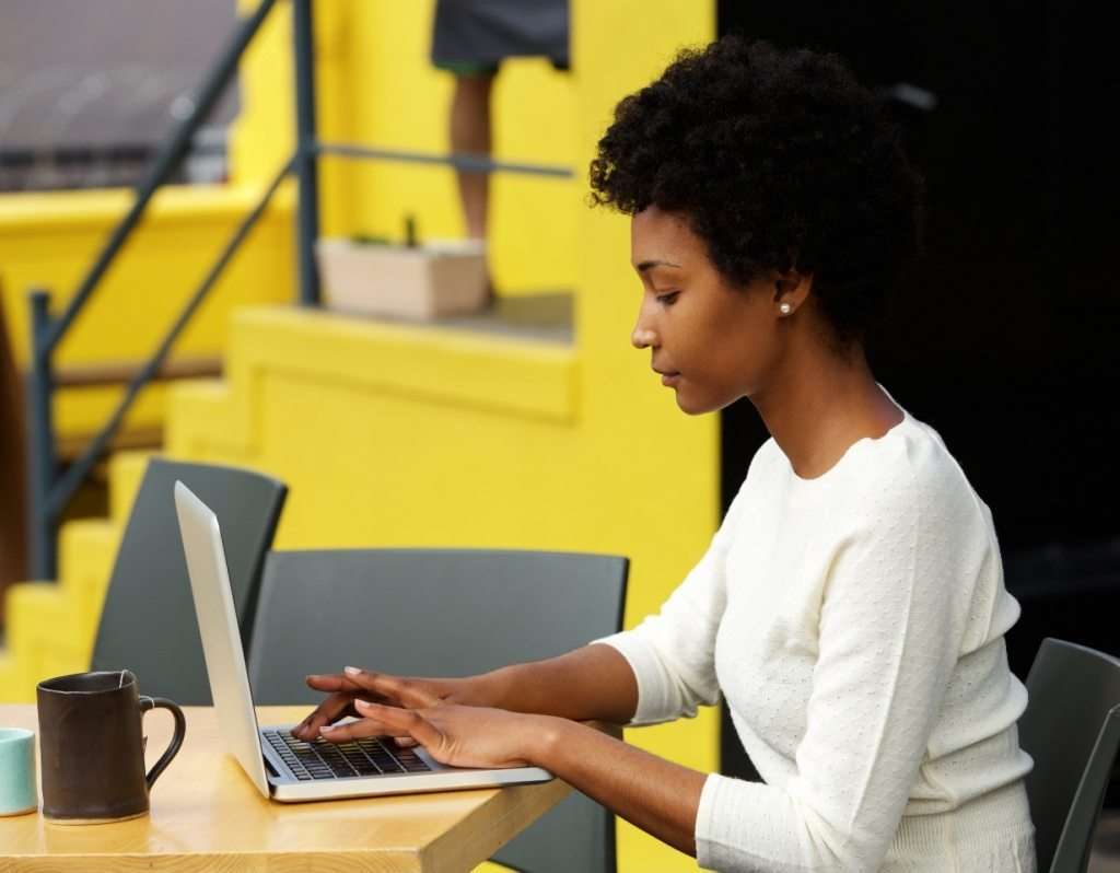 attractive-young-woman-using-laptop-outside-P9RLFGU@2x-1024x798-1.jpg